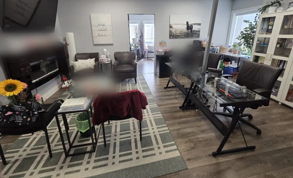 Reception and waiting room at the Mississauga office, with armchairs, a front desk and bookshelves.