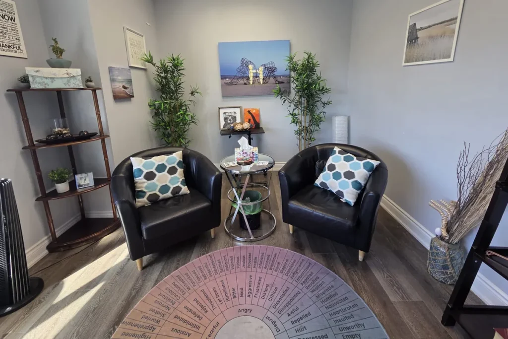 Two leather armchairs with patterned cushions facing each other in a calm therapy room in Mississauga